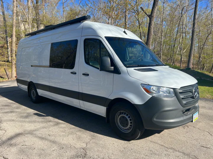 White Mercedes Sprinter camper van, equipped with an awning, perfect for rv rental adventures.. Mercedes-Benz Sprinter RV Motorhome Campervan 2022