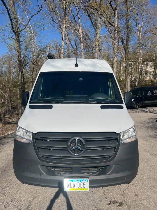 Front view of a white Mercedes-Benz Sprinter van, an ideal RV rental vehicle, with Iowa plate NEN 365.. Mercedes-Benz Sprinter RV Motorhome Campervan 2022