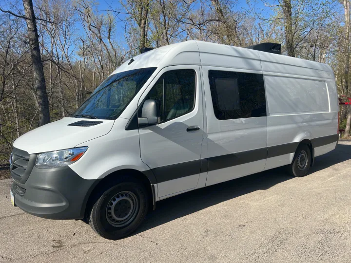 White Mercedes Sprinter camper van parked on asphalt, perfect for an rv rental getaway.. Mercedes-Benz Sprinter RV Motorhome Campervan 2022