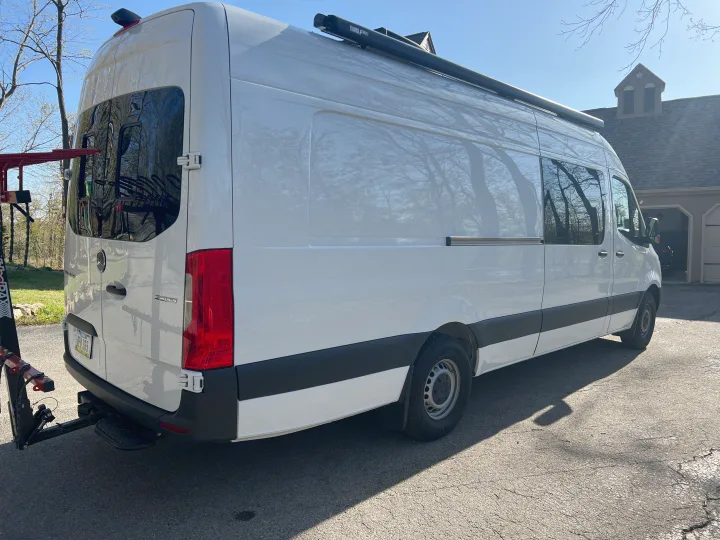 White Mercedes Sprinter camper van for your next RV rental adventure. Equipped with awning & bike rack.. Mercedes-Benz Sprinter RV Motorhome Campervan 2022