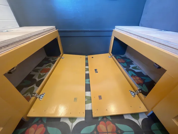 RV rental custom build: Open yellow storage benches with a colorful patterned floor inside, ideal for maximizing space.. Mercedes-Benz Sprinter RV Motorhome Campervan 2022