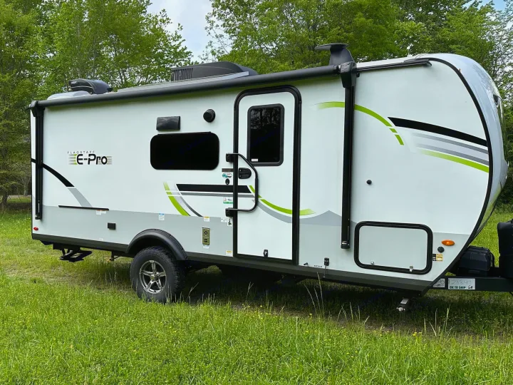 Modern Flagstaff E-Pro travel trailer in a grassy field, ideal for your next RV rental adventure.. Forest River Flagstaff E-Pro 2023