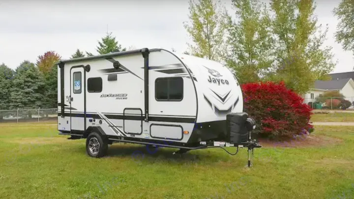 Jayco Jay Feather Micro travel trailer, a compact white & black RV rental, parked on grass for your next adventure.. Jayco 166 FBS 2022