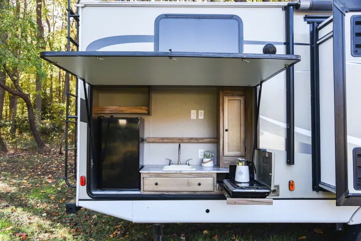 Explore the outdoors with this RV rental! Features a full exterior kitchen: fridge, sink, & stove. Perfect for camping.. Coachmen Freedom Express 2018