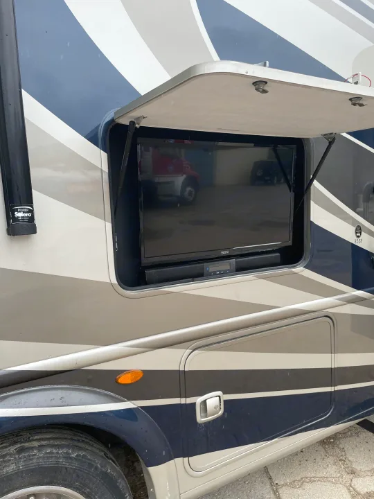 This RV rental features an open outdoor entertainment compartment with a large TV and soundbar, perfect for tailgating.. Thor Chateau 2018
