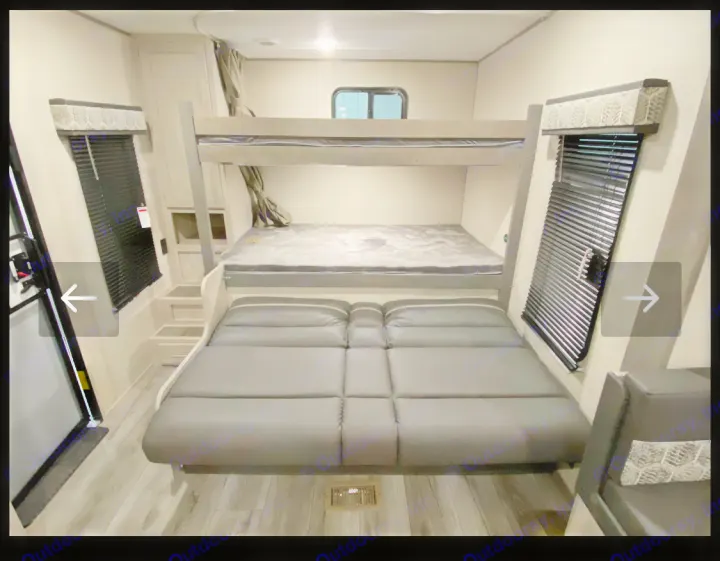 Spacious RV rental interior featuring comfortable bunk beds and convertible seating. Perfect for families on the go.. Coachmen Summit series 2023