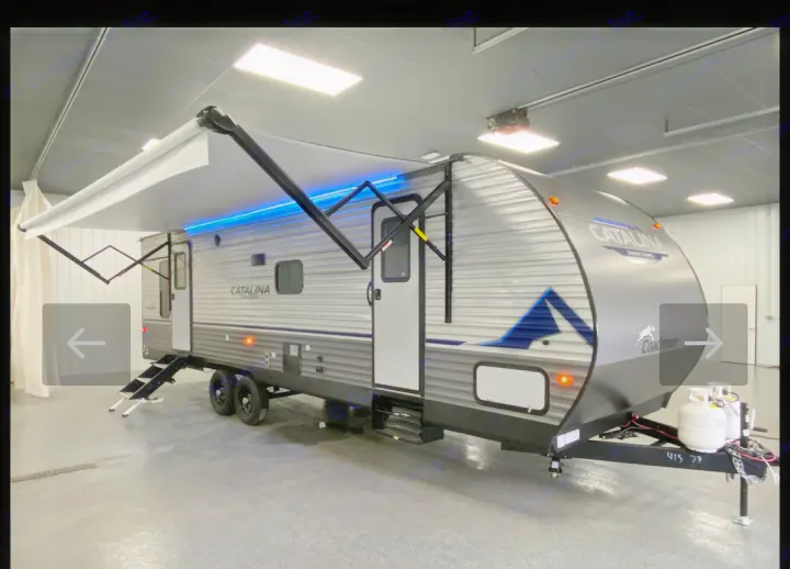 This sleek grey travel trailer, a Coachmen Catalina, is ready for your next rv rental adventure, featuring a lit awning & convenient steps.. Coachmen Summit series 2023