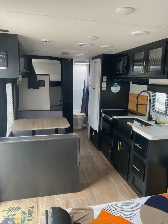 Modern RV rental interior showcasing a full kitchen, dinette, and cozy bunk beds. Ideal for your next adventure.. Forest River Cherokee Grey Wolf Special Edition 2022