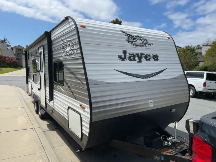 Front view of a Jayco travel trailer, a great RV rental option for your next camping adventure, parked on a sunny day.. Jayco Jaycoflight 2017