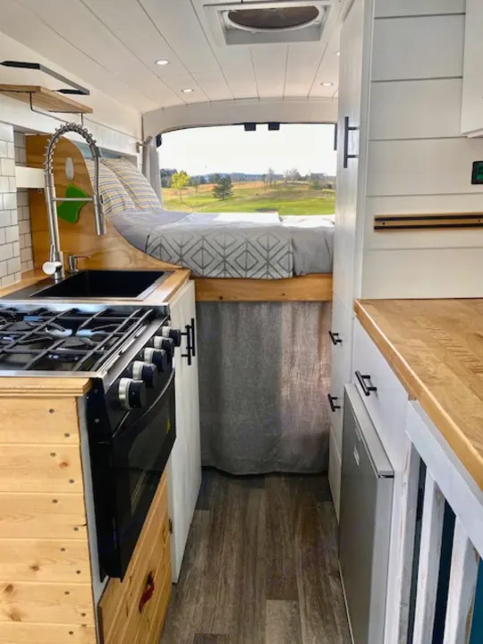 Experience cozy road trips in this RV rental! Features a fully equipped kitchen, elevated bed, and scenic views.. Ford Transit Custom 2015