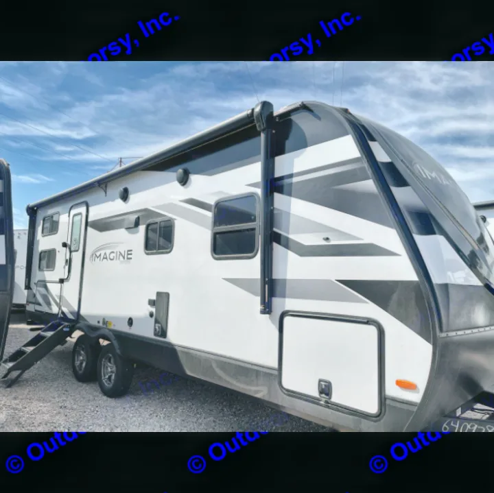 Sleek white and black travel trailer with an extended awning, ideal for your next rv rental adventure. See its exterior.. Grand Design Imagine 2022