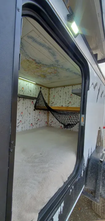 RV rental: Inside this cozy camper, a map lines the ceiling, bird walls, a soft bed, and a storage net.. Haulmark Homesteader 2005