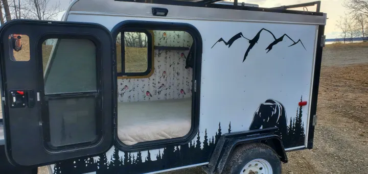 Cozy RV rental camper: custom bear and mountain exterior, warm interior with birch tree & bird wallpaper. Perfect for outdoor adventure.. Haulmark Homesteader 2005