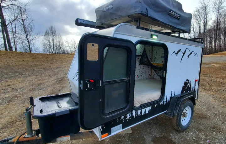 Compact overland camper with rooftop tent, ideal for your next RV rental adventure. Ready for the great outdoors!. Haulmark Homesteader 2005