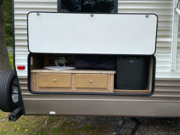 RV rental with convenient outdoor kitchen, featuring a sink, drawers, and fridge, perfect for camping adventures.. Forest River Shasta Revere 2016