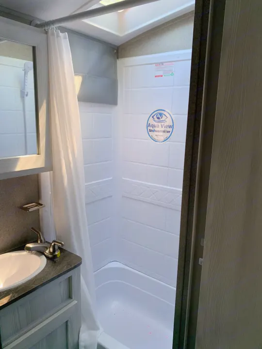 Clean RV rental bathroom with sink, vanity, and shower/tub combo, perfect for your next adventure.. Forest River Rockwood Geo Pro 2020