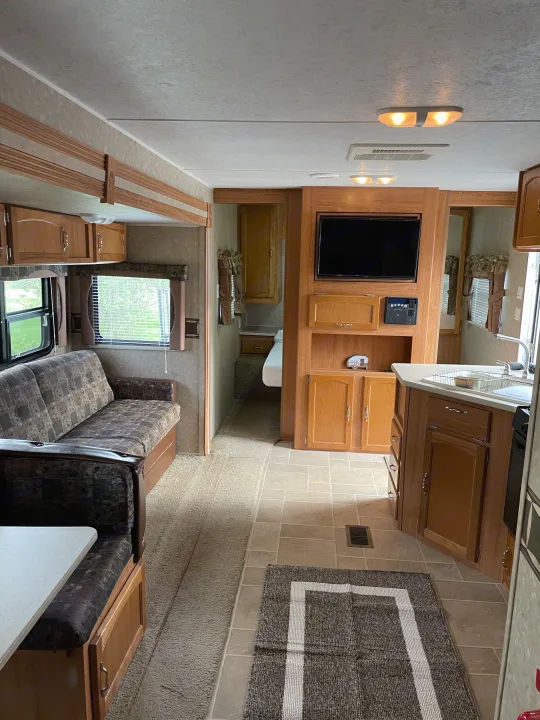 Step inside this spacious rv rental. Features a comfortable living area, kitchen, and bedroom.. Puma 30DBSS 2009