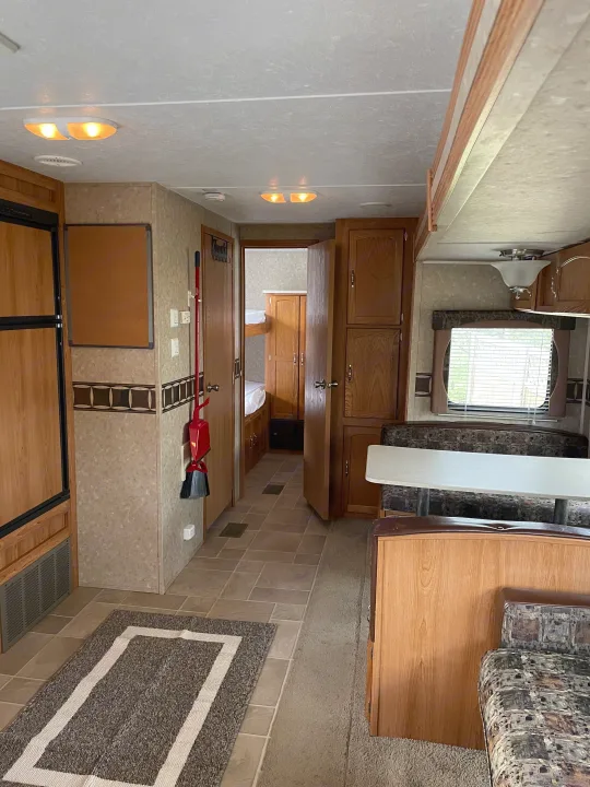 Spacious RV rental interior showing kitchen, dining, and hallway leading to bunk beds. Perfect for family adventures!. Puma 30DBSS 2009