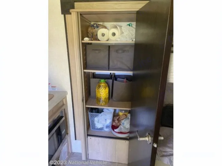 RV rental pantry with organized shelves of food, oil, toilet paper, and storage bins for easy access.. Forest River R-Pod 2020