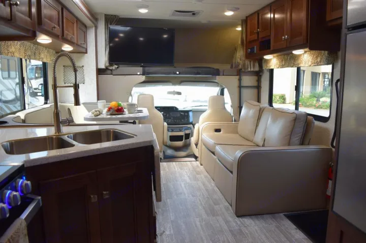 Modern RV rental interior with a fully equipped kitchen, comfortable living area, and overhead bunk.. Forester Forester Motorhome 2020