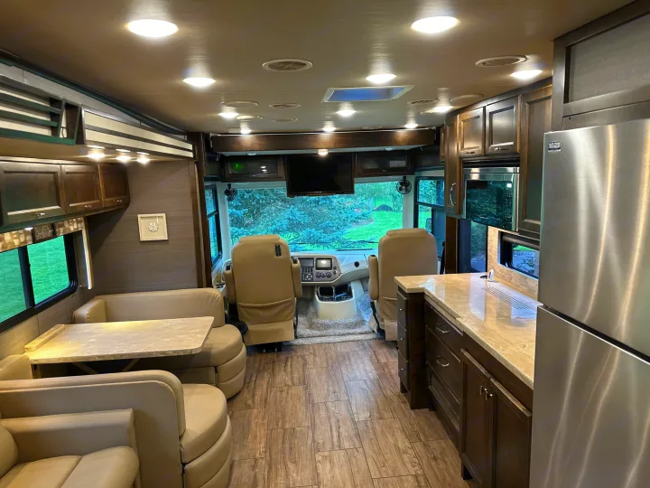 Explore this luxurious rv rental interior with living, dining, kitchen, and cockpit areas, ready for your next adventure.. Allegro Allegro Open Road 2019