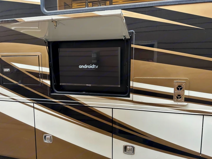 Side of an RV rental showing an outdoor Hisense Android TV screen with 'androidtv' logo. Ready for entertainment!. Allegro Allegro Open Road 2019