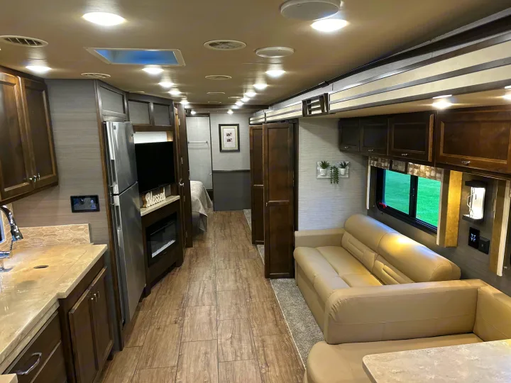 Spacious RV rental: modern living area with sofa, full kitchen, and rear bedroom. Brightly lit, comfortable interior.. Allegro Allegro Open Road 2019