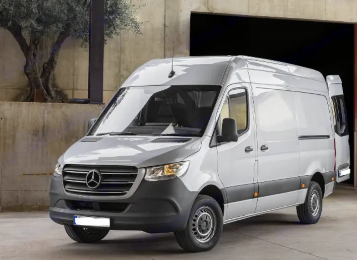 A light gray Mercedes Sprinter van, often used for RV rental conversions, parked outdoors near a garage entrance.. Mercedes-Benz Sprinter 2021