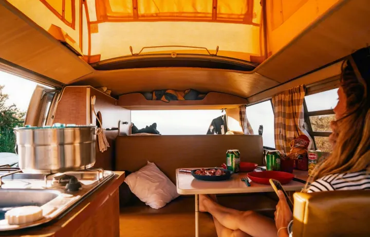 Experience the comfort of an rv rental: relaxing with a meal & sunset views from your camper van kitchen.. Volkswagen T2 Westfalia 1971