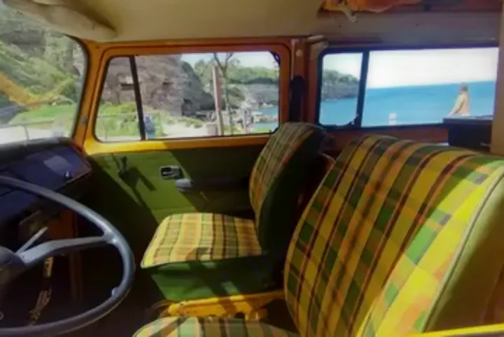 Step inside this vintage RV rental, featuring cozy plaid seats and a steering wheel, overlooking a scenic ocean view. Perfect for your road trip!. Volkswagen T2 Westfalia 1976