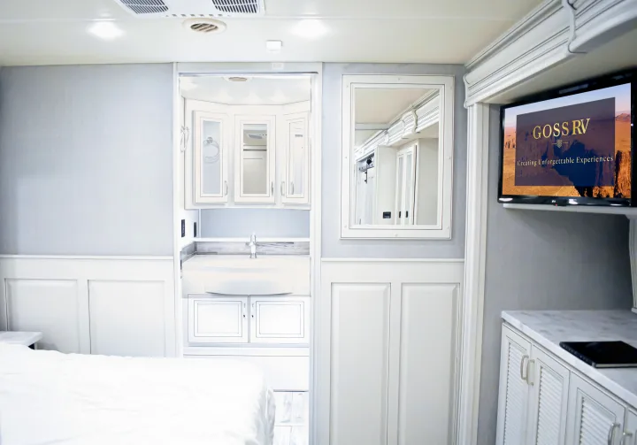Step inside this modern luxury RV rental, featuring a spacious bedroom, vanity, & TV for unforgettable trips.. Holiday Rambler Endeavor 2022