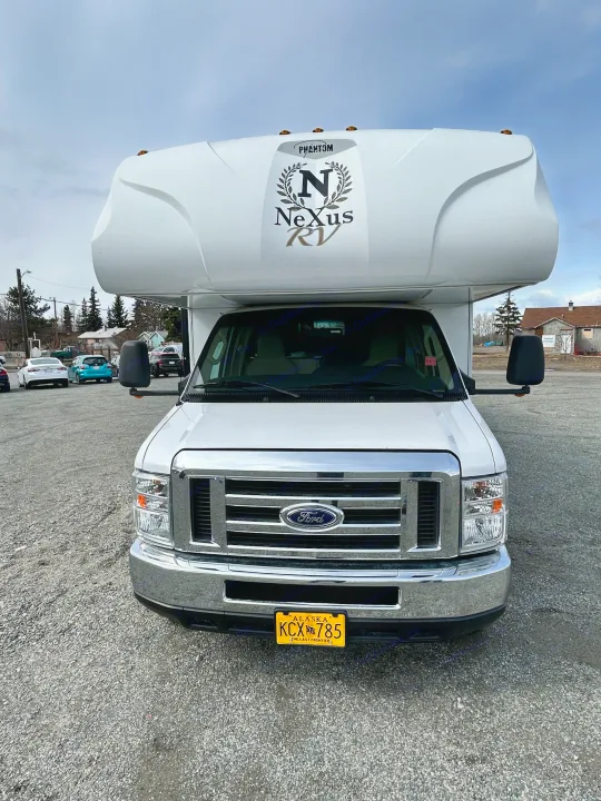 White Ford Nexus Class C RV rental, front view. Parked with Alaska license plate KCX 785.. Nexus Phantom 2018