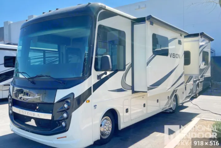White & black Entegra Vision Class A RV, with slide-outs extended for space. Perfect for your next rv rental.. Entegra Coach Vision 2021