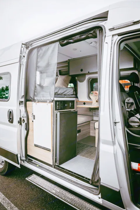 Step inside this RV rental! A well-designed camper van interior reveals a bed, living space, and amenities for your road trip.. Winnebago Solis Pocket 2022