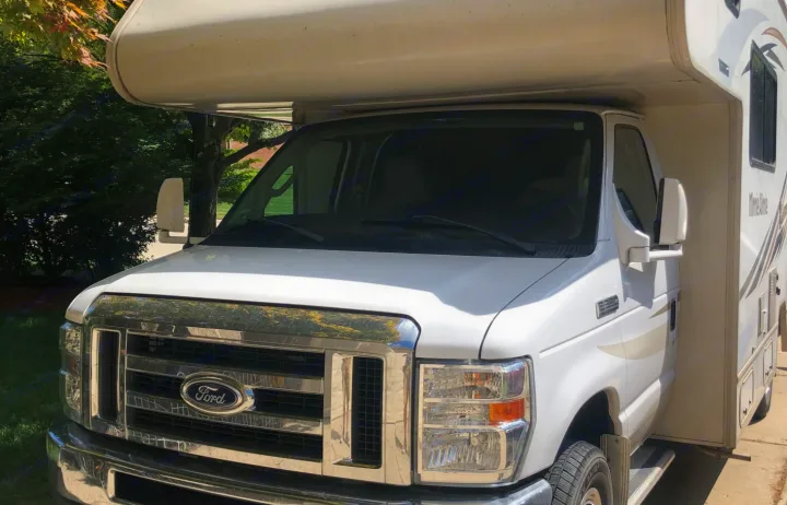 White Ford Minnie Winnie Class C RV from the front and side, ready for your next rv rental trip.. Winnebago Minnie Winnie 2016