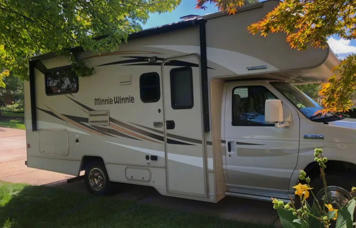 Get ready for an adventure! This light-colored Class C Minnie Winnie recreational vehicle is ideal for an RV rental. Parked outdoors.. Winnebago Minnie Winnie 2016