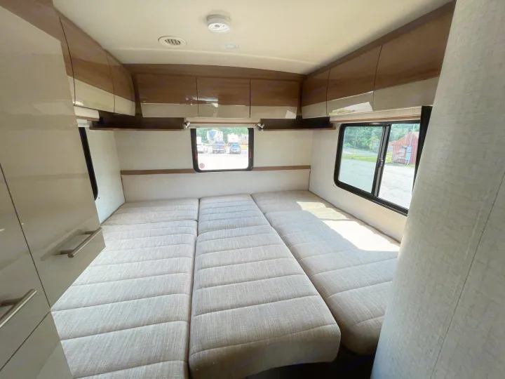 Spacious RV interior with modular bed/seating, modern cabinets, and large windows. Perfect for your next rv rental.. Itasca Navion 2015