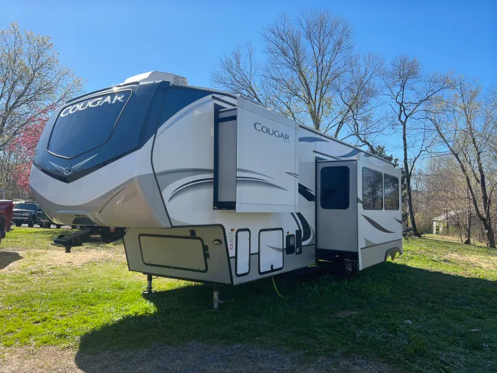Enjoy outdoor living! This white and grey Cougar fifth-wheel RV, with extended slide-outs, is perfect for your rv rental.. Keystone RV Cougar 364 BHL 2022