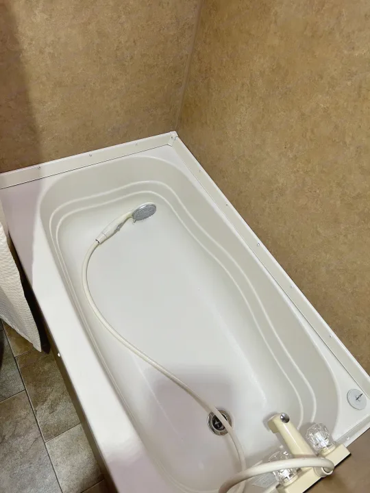 Compact RV rental bathroom with white bathtub and handheld shower.. Jayco Jay Flight Swift 154 BH Slx 2013