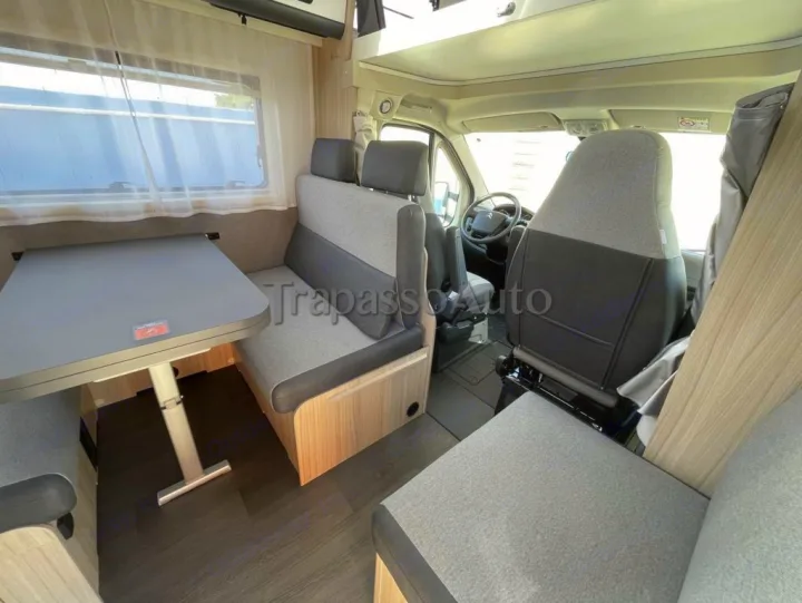 Spacious RV rental interior with a cozy dining area and swiveling front seats, ready for comfortable travel.. SunLiving A 75 DP 2024