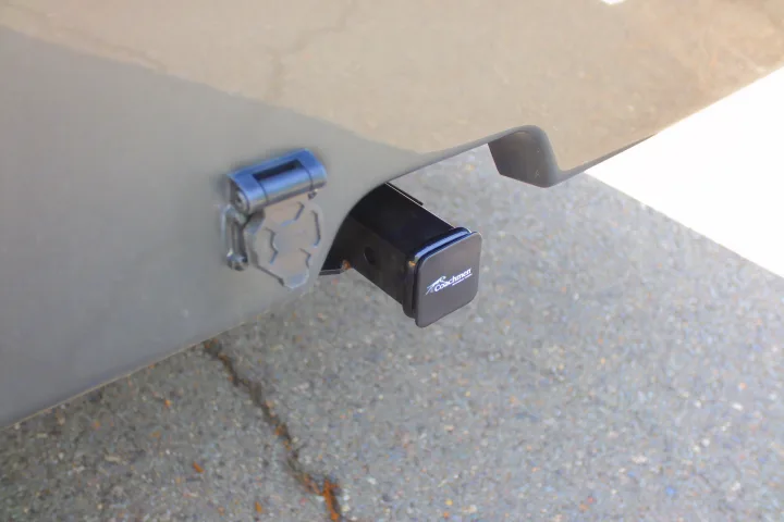 RV rental: Rear view showing a 7-pin electrical connector and Coachmen hitch receiver for towing.. Coachmen Encore 2024