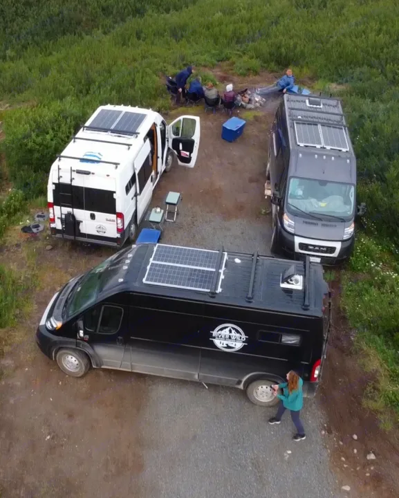 Three camper vans, all with solar panels, parked for a campfire gathering. Great for an outdoor rv rental trip.. Dodge Promaster 2500 (Class B) 2022
