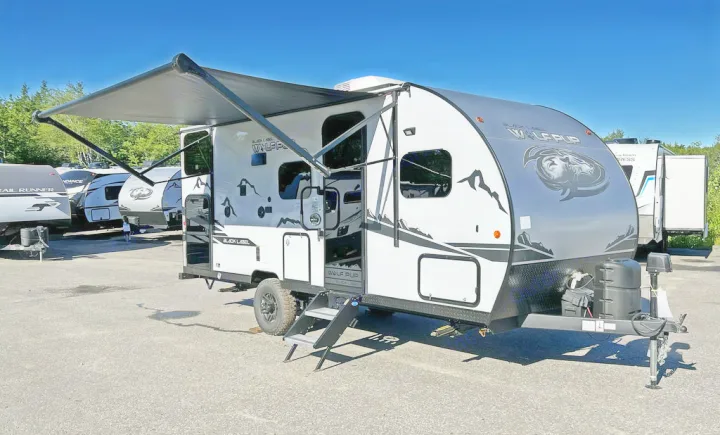 White and gray Wolf Pup travel trailer with extended awning and steps, perfect for your next rv rental adventure.. Forest River Cherokee Wolf Pup Black Label 2022