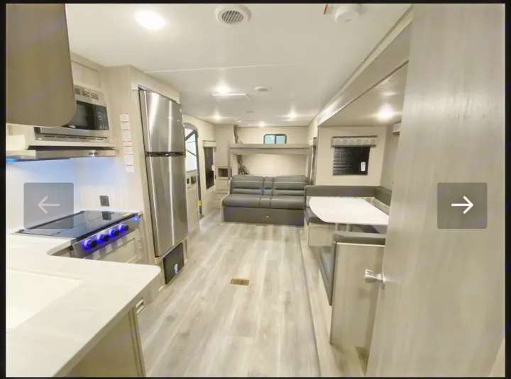 Spacious RV rental interior: kitchen, dinette, sofa, bunk beds. Modern, comfortable camper layout.. Coachmen Catalina 2023