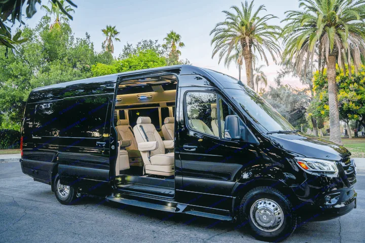 Luxury black Mercedes-Benz Sprinter van, side door open to reveal plush tan interior, perfect for an upscale RV rental.. Ultimate Toys Ultimate Coach 2023