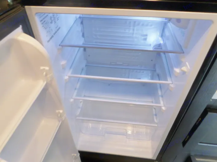 Clean RV rental refrigerator interior with clear shelves and door storage, ready for your trip.. Braxton Creek Bushwhacker Plus 2022