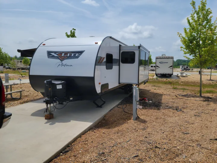 This RV rental travel trailer is perfectly set up on site 418 at a spacious RV park, ready for adventure.. Forest River 31bhxl 2023