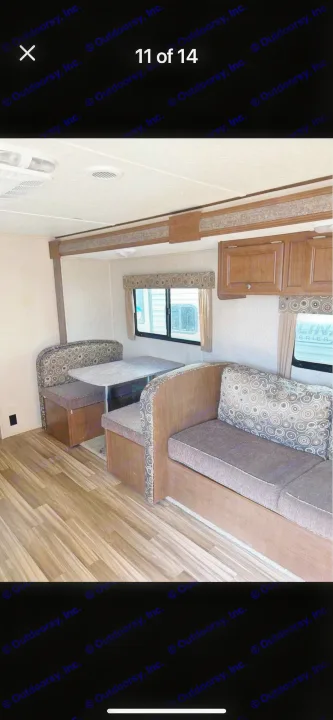 Inside your next **RV rental**: A well-appointed dinette, comfortable sofa, overhead cabinets, and large windows.. Shasta Oasis 2016