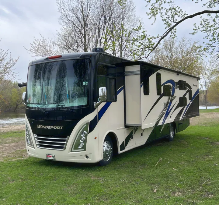 This Windsport Class A rv rental, with its slide-out extended, is perfectly parked by the river for your outdoor escape.. Thor Windsport 2023