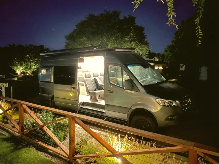 This illuminated Sprinter van, great for an RV rental, shows its spacious interior & seating at night, ready for your next adventure.. Mercedes-Benz Sprinter 2020
